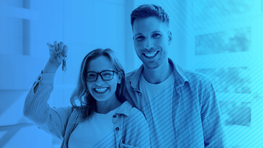 Photo of two people with one person holding keys.